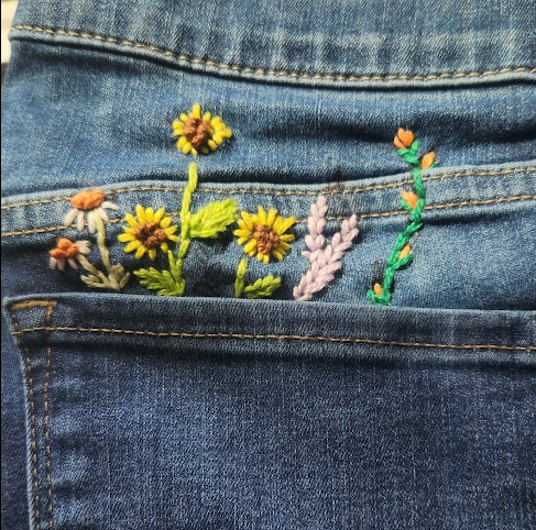 Embroidered flowers on jean pocket